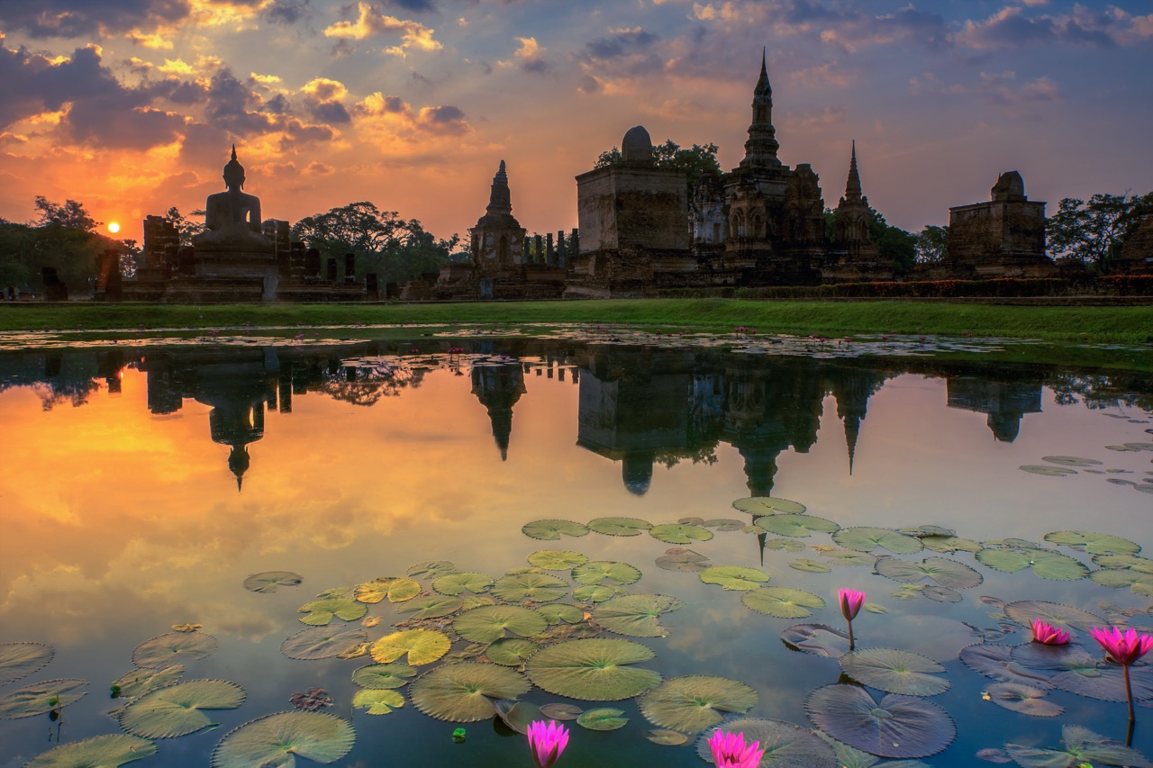 Sukhothai Historical Park in the cool season — clear morning sky above stone temple ruins